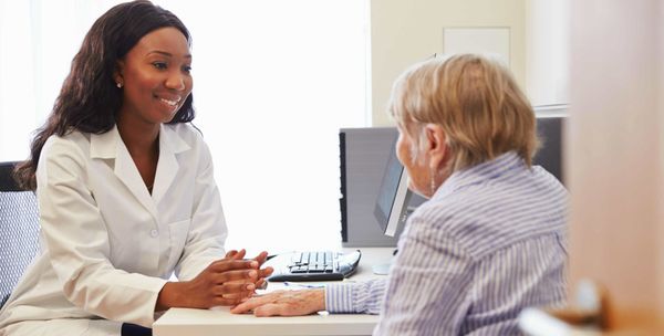 Pharmacist reviewing medications with a patient