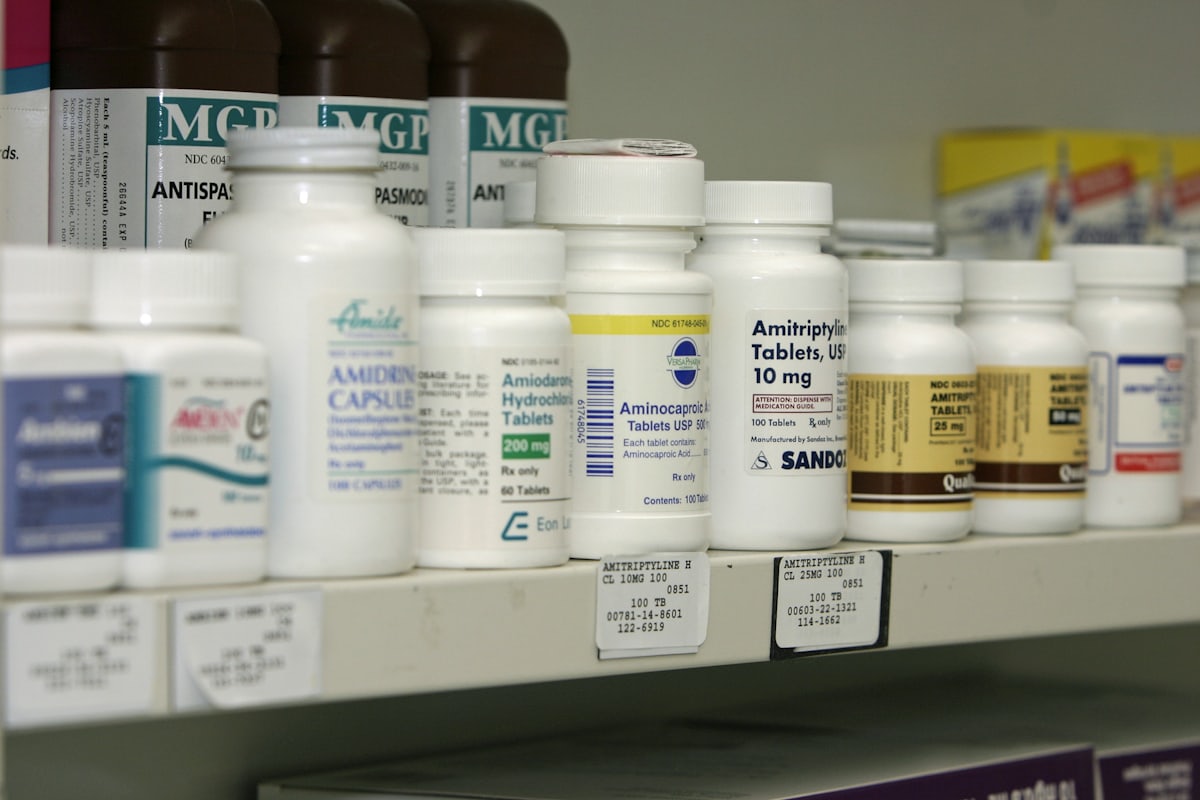 Pharmacy shelf stocked with medicine bottles